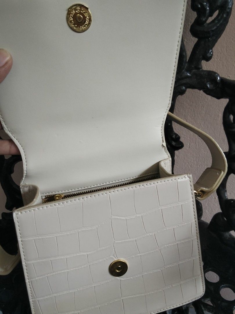 JW Pei Cream Croc Embossed Shoulder Bag (Category: Shoulder Bags) located in Bugasong. Submitted by sofiewaffle (Listing ID 1441920013, Image 2). Description: - Elegant cream shoulder bag - Luxurious croc embossed texture - Stylish gold hardware details - Secure zipper closure inside - Convenient magnetic snap flap closure - Adjustable strap for a customized fit - Clean and spacious interior - Ideal for everyday use and carrying your essentials -