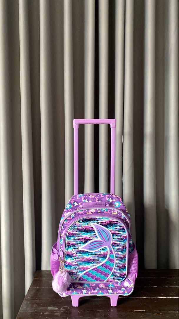 KIDS Purple Mermaid Sequin Stroller Backpack School bag (Category: Backpacks) located in Antipolo. Submitted by gaeumi (Listing ID 1441833115, Image 2). Description: ✦ never used ✦ with wheels, 2 water compartments, sequins, keychain, working zippers ✦ needs cleaning ✦ convertible to backpack ✦ has a small stain (please see photo) ✦ has 2 compartments - small (front) and big (with inner compartment).