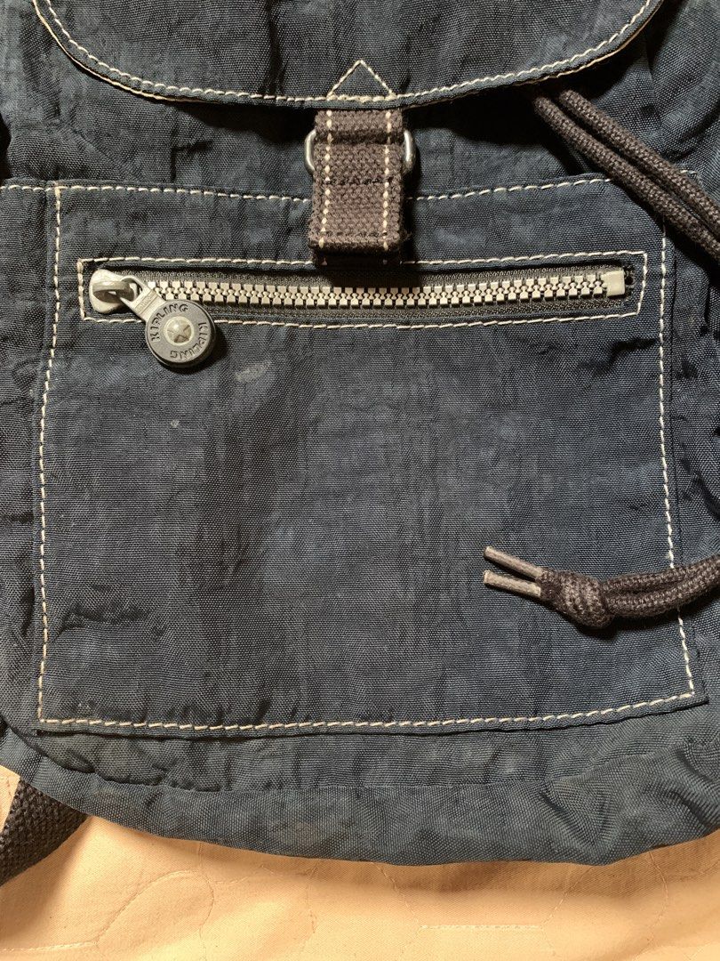 Kipling Navy Blue Nylon Backpack with Monkey Keychain (Category: Backpacks) located in Cagayan de Oro. Submitted by akidomingo088 (Listing ID 1441792881, Image 3). Description: - Navy blue Kipling backpack - Durable nylon material - Secure drawstring and buckle flap closure - Convenient front zip pocket - Small pocket on the flap - Includes signature Kipling monkey keychain - Adjustable shoulder straps - Ideal for everyday use.