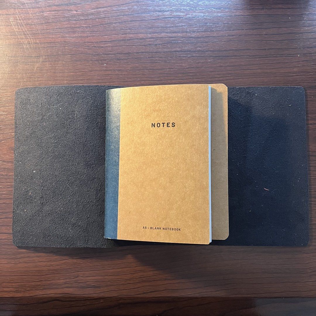 Leather Journal Folio (A6, trifold) (Category: Stationery & School Supplies) located in Quezon City. Submitted by lucky.girlll (Listing ID 1441829020, Image 3). Description: - Black leather cover for standard A6 blank notebooks. (notebooks not included) - Elastic band closure keeps your notebook securely shut. - Interior slots hold your notebook in place. - Ideal for journaling and note-taking on the go. - Keeps your notes secure and organized..