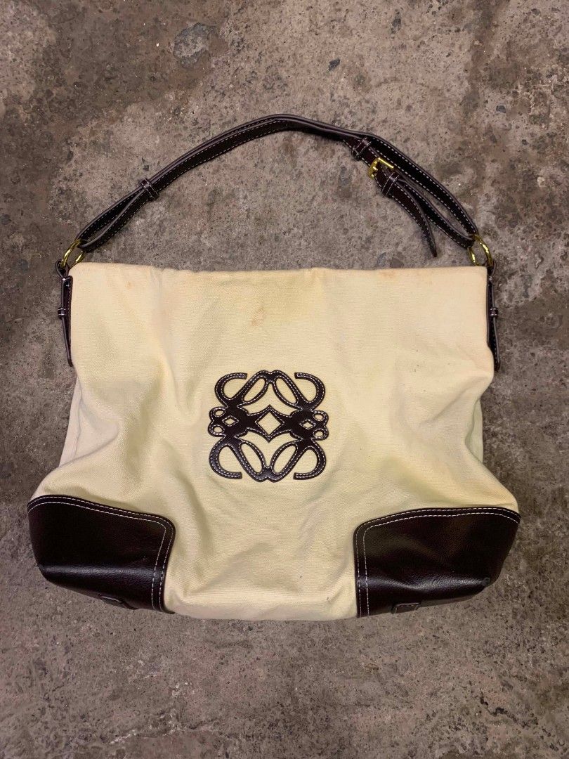 Loewe Canvas and Leather Shoulder Bag (Category: Luxury Bags & Wallets) located in Polomolok. Submitted by warmfire.3185dd (Listing ID 1441961338, Image 1). Description: - Loewe shoulder bag - Cream canvas body - Dark brown leather trim and handles - Iconic Loewe anagram logo on front - Interior zippered pocket - Minor marks on canvas - Slight scuffing on leather corners - Need wash - With very minimal, unnoticeable issue.