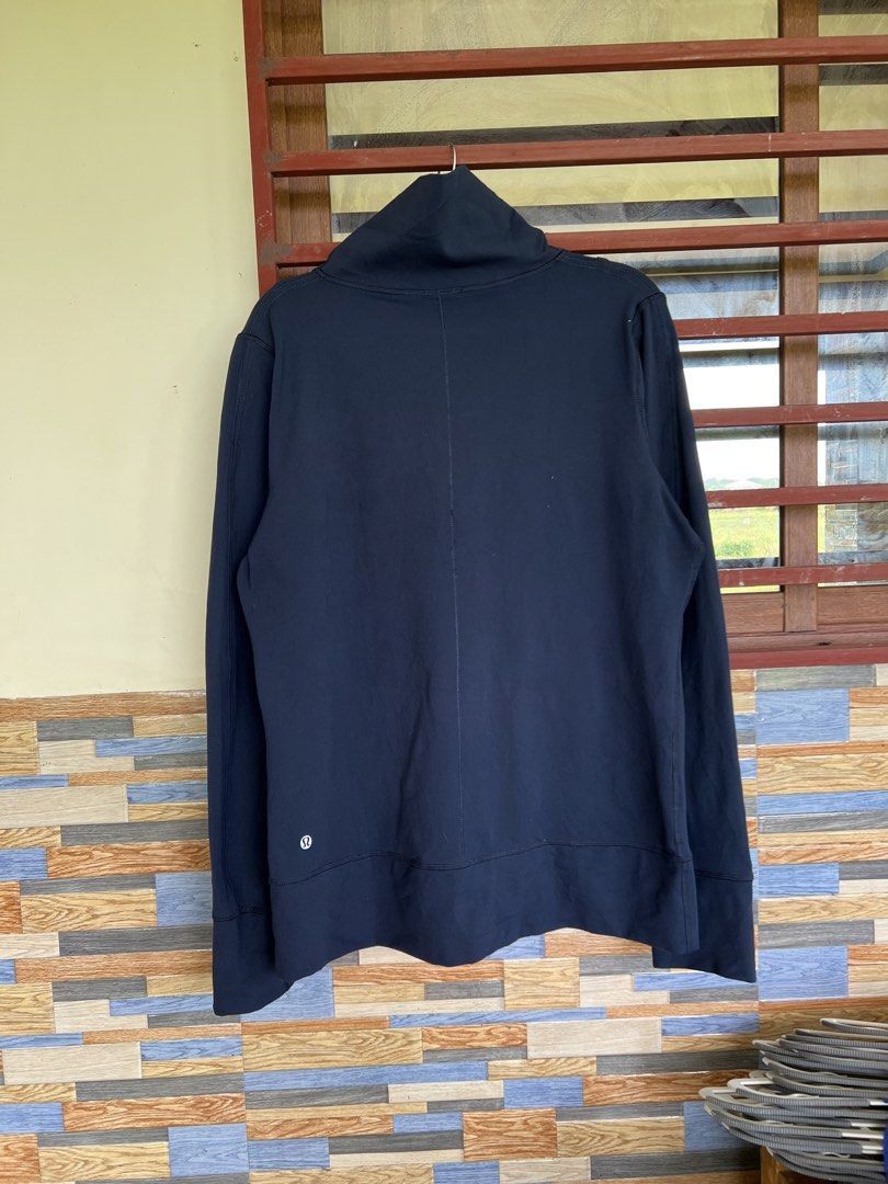 Lululemon Athletica Navy Blue Full Zip Jacket (Category: Coats, Jackets and Outerwear) located in Iba. Submitted by saploot (Listing ID 1441908128, Image 2). Description: - Navy blue Lululemon jacket - Full zip closure with a high collar - Front pockets with zipper pulls - Lululemon logo on back hem and one zipper pull - Ideal for workouts or casual wear.