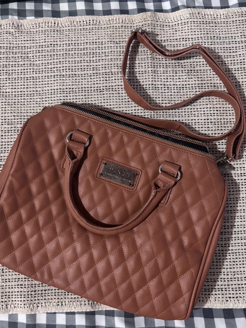 Mango Quilted Satchel Bag (Category: Luxury Bags & Wallets) located in Pasay City. Submitted by alt.collectives (Listing ID 1441867982, Image 1). Description: - Features top handles and a detachable shoulder strap - Secure zipper closure - Elegant metal logo plate on the front - Ideal size for carrying daily essentials.