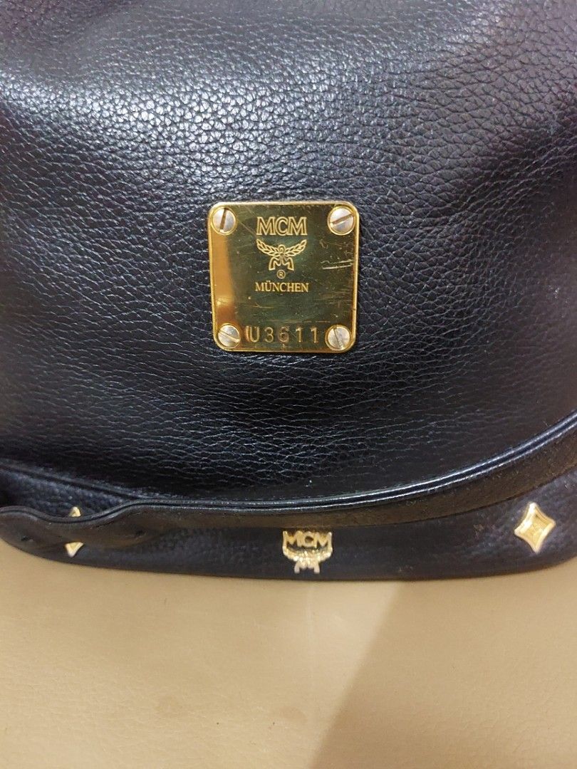 MCM Germany Black Leather Bucket Bag (Category: Luxury Bags & Wallets) located in Las Pinas. Submitted by jmproperties (Listing ID 1441781276, Image 2). Description: - Authentic MCM bucket bag Germany - Color: Black leather - Hardware: Gold size : large - Closure: Drawstring - Strap: Adjustable - A timeless addition to your collection Details: Genuine pebbled leather exterior Gold-tone hardware and logo plaque Drawstring bucket closure Adjustable