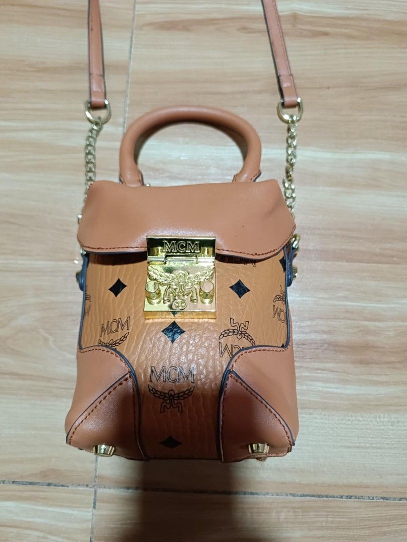 MCM Visetos Mini Bag with Top Handle and Strap (Category: Luxury Bags & Wallets) located in Manila. Submitted by jheizkiehi39708 (Listing ID 1441963715, Image 2). Description: - Classic Visetos print - Top handle and detachable shoulder strap - Gold-tone hardware with MCM logo clasp - Interior tag: 'Made in Germany' - Ideal for carrying daily essentials.