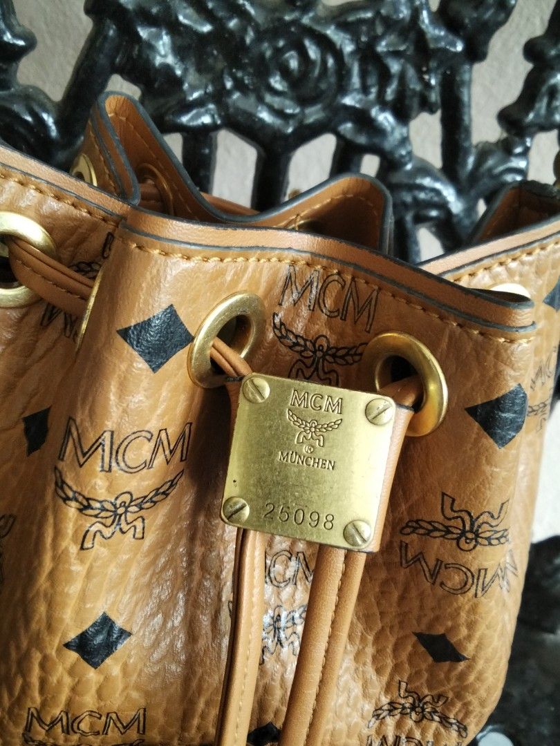 MCM Visetos Mini Bucket Bag with Chain Strap (Category: Luxury Bags & Wallets) located in Bugasong. Submitted by sofiewaffle (Listing ID 1441903703, Image 2). Description: - Authentic MCM bucket bag - Classic Visetos print - Gold chain strap - Drawstring closure - Interior leather patch and 'Made in Korea' tag - Stylish and compact - Ideal for carrying essentials -negotiable for sure buyers .