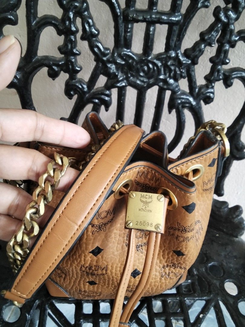 MCM Visetos Mini Bucket Bag with Chain Strap (Category: Luxury Bags & Wallets) located in Bugasong. Submitted by sofiewaffle (Listing ID 1441903703, Image 3). Description: - Authentic MCM bucket bag - Classic Visetos print - Gold chain strap - Drawstring closure - Interior leather patch and 'Made in Korea' tag - Stylish and compact - Ideal for carrying essentials -negotiable for sure buyers .