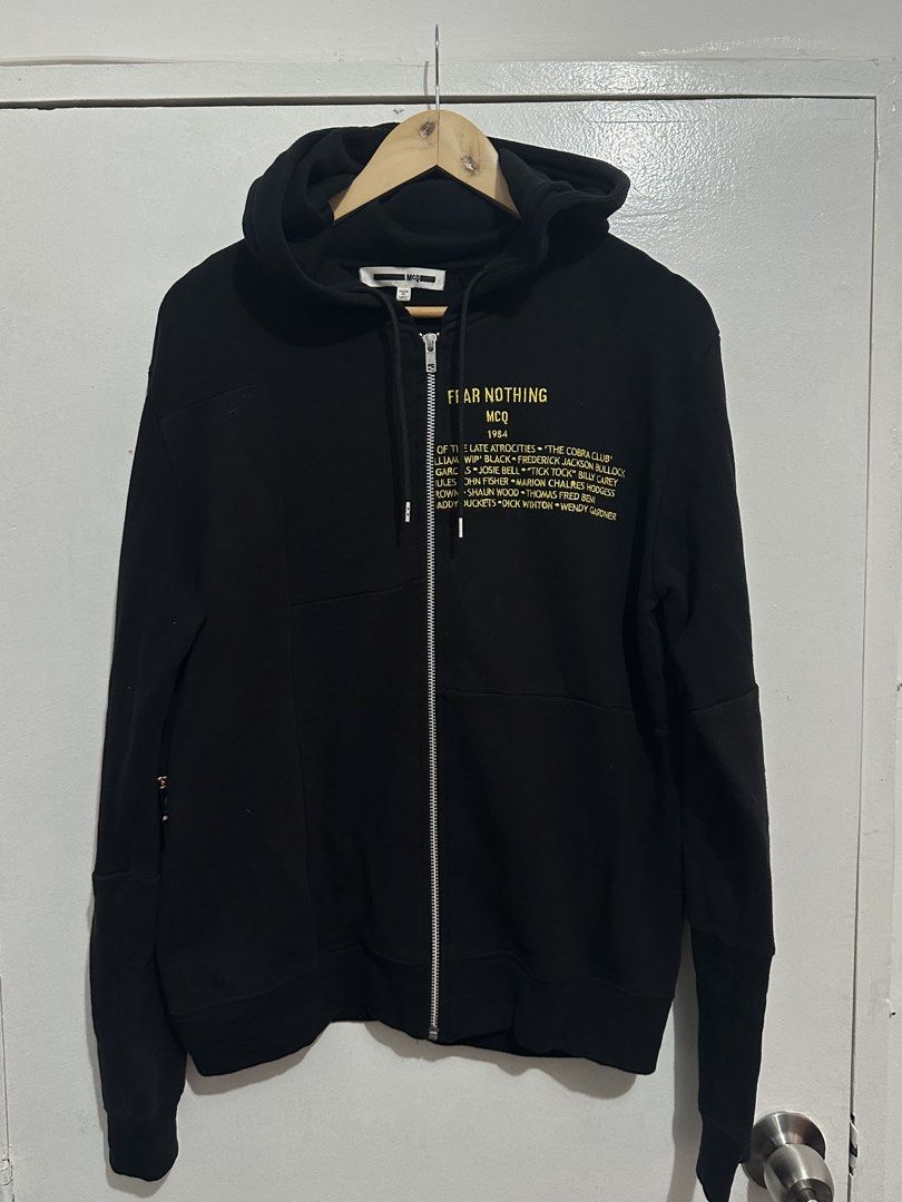 MCQ "FEAR NOTHING" Black Zip-Up Hoodie (Category: Hoodies) located in Manila. Submitted by markjason420 (Listing ID 1441867775, Image 1). Description: - MCQ Black Zip-Up Hoodie - 'FEAR NOTHING' graphic on front with names - 'COBRA CLUB' graphic on back - Unique panel design on sleeves - Full zip closure - Comfortable and stylish.