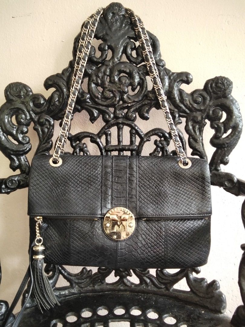 METROCITY Black Python Embossed Leather Chain Shoulder Bag (Category: Luxury Bags & Wallets) located in Bugasong. Submitted by sofiewaffle (Listing ID 1441920383, Image 1). Description: - Black METROCITY shoulder bag - Python embossed leather exterior - Gold hardware with tassel detail - Chain strap - Multiple interior compartments and zip pocket - Clean interior - Versatile for day or night use -negotiable for sure buyer.