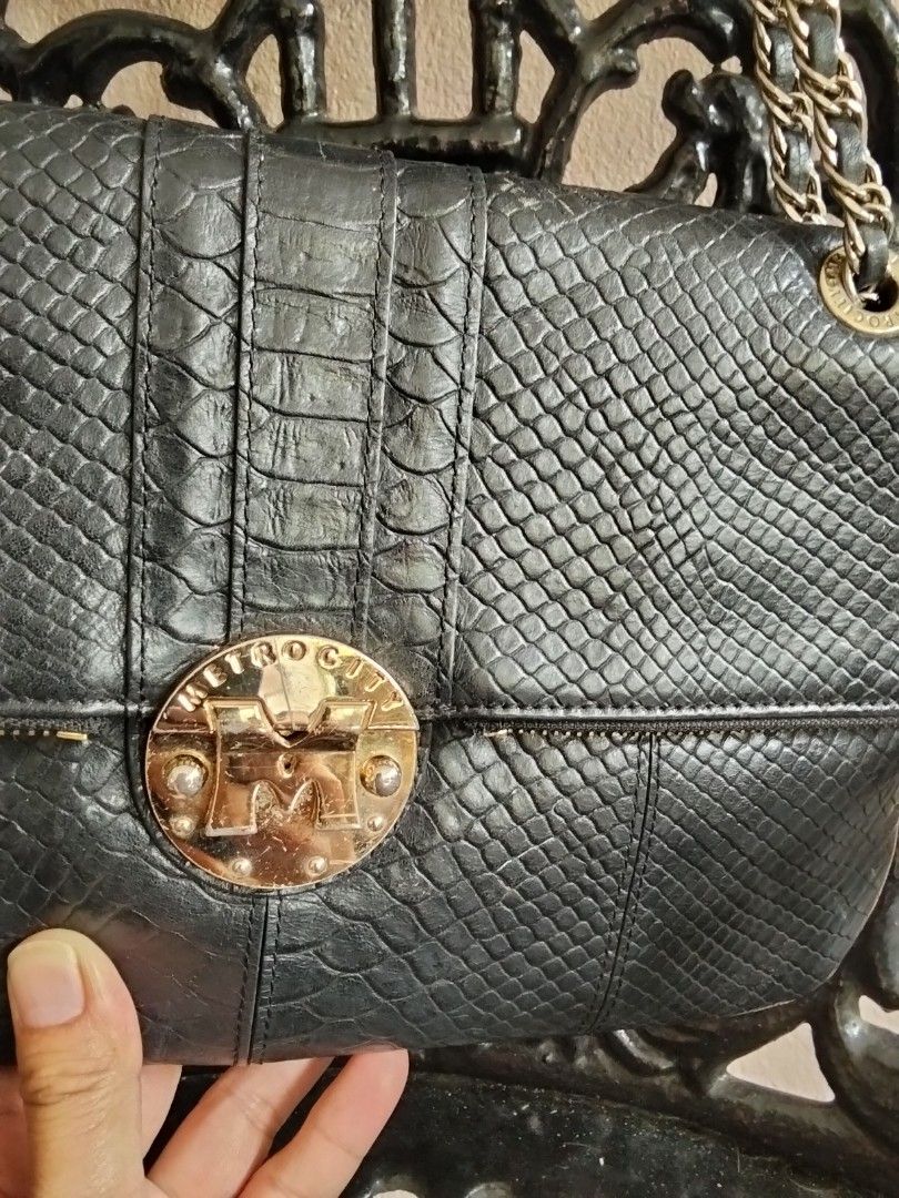 METROCITY Black Python Embossed Leather Chain Shoulder Bag (Category: Luxury Bags & Wallets) located in Bugasong. Submitted by sofiewaffle (Listing ID 1441920383, Image 2). Description: - Black METROCITY shoulder bag - Python embossed leather exterior - Gold hardware with tassel detail - Chain strap - Multiple interior compartments and zip pocket - Clean interior - Versatile for day or night use -negotiable for sure buyer.