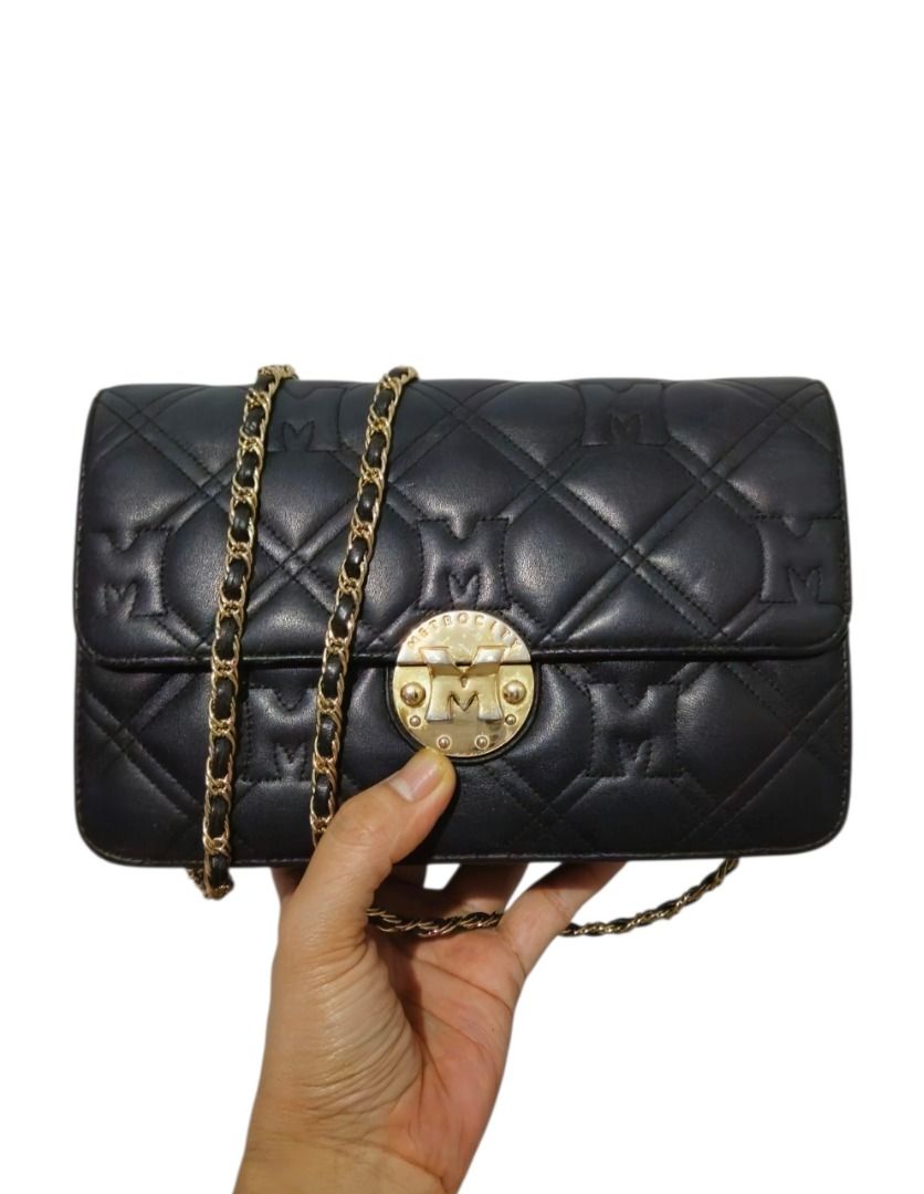 Metrocity Black Quilted Chain Bag (Category: Shoulder Bags) located in Quezon City. Submitted by kirstenbella (Listing ID 1441830536, Image 1). Description: 💯Authentic Metrocity - Stylish black quilted shoulder bag - Genuine leather - Elegant gold chain strap - Front circular gold clasp with logo detail - Interior zippered compartment for secure storage - Lining features a repeating logo pattern - Ideal for carrying your daily essentials - In Ex
