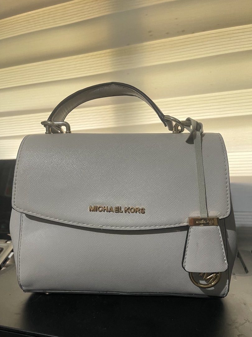 Michael Kors Light Blue Leather Top Handle Bag (Category: Luxury Bags & Wallets) located in Manila. Submitted by silvertree_1da22e (Listing ID 1441944963, Image 2). Description: Light blue Michael Kors handbag. Saffiano leather. Has a top handle and a crossbody strap. Comes with a Michael Kors charm. Clean interior. Great for everyday use. All in good condition 1500 each .