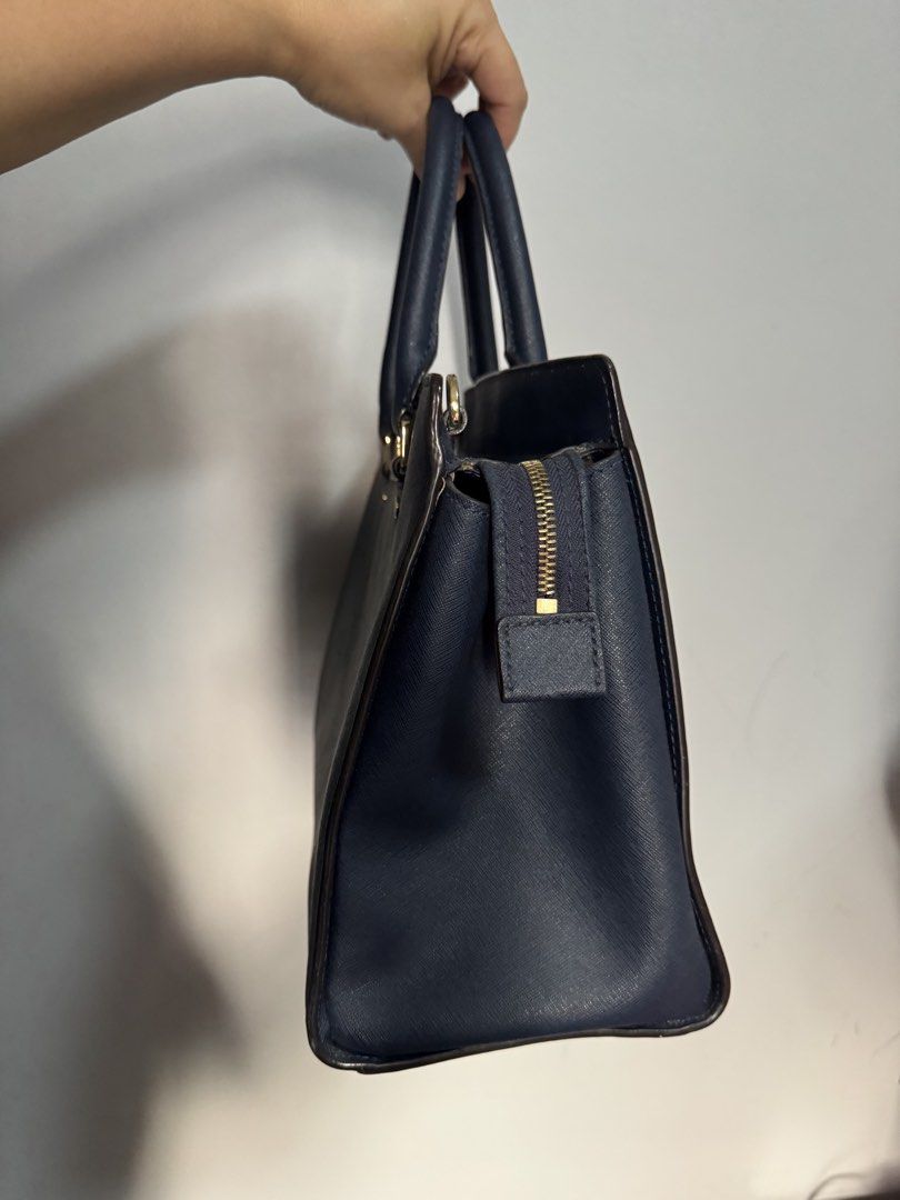 Michael Kors Navy Blue Leather Tote Bag (Category: Luxury Bags & Wallets) located in Santa Rosa. Submitted by shieladizon (Listing ID 1441786034, Image 3). Description: - Navy blue Michael Kors tote bag - Genuine Saffiano leather - Elegant gold hardware details - Comfortable top handles for carrying - Secure zipper closure - Ample, spacious interior - Ideal for everyday errands or professional settings.