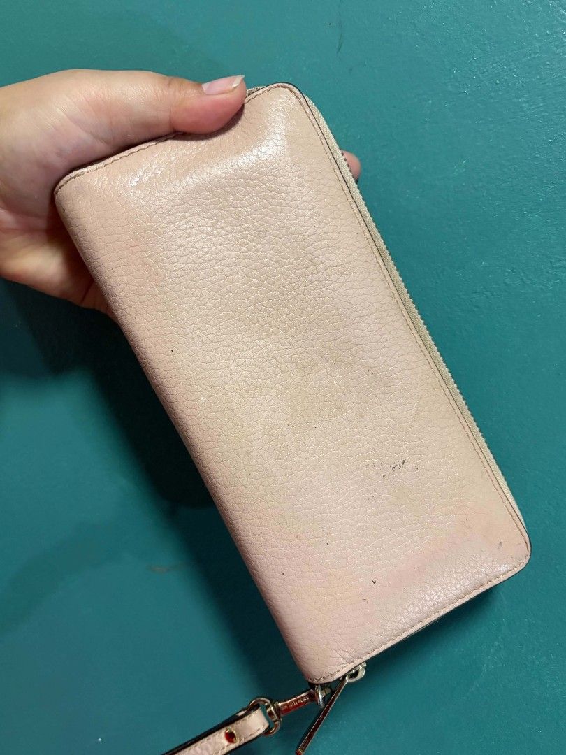 Michael Kors Pink Leather Zip Around Wallet (Category: Wallets & Card holders) located in General Trias. Submitted by happystorm_b8e70b (Listing ID 1441798556, Image 2). Description: - Michael Kors wallet - Light pink color - Genuine leather material - Zip-around closure - Attached wrist strap - Minor exterior wear (as pictured) - Ample interior space for cards and cash - Ideal for everyday use.