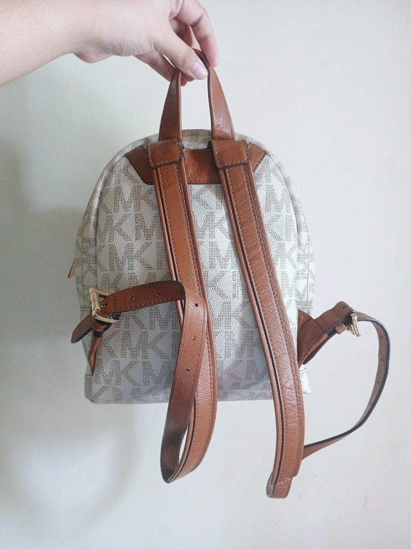 AUTHENTIC Michael Kors Signature Logo Canvas & Leather Mini Backpack (Category: Backpacks) located in Naga. Submitted by thesericollection (Listing ID 1441805108, Image 3). Description: NOTE: Item is available for bargain but please review all photos before purchasing. Product has a minor sign of wear on leather trim and needs cleaning. •Guaranteed Authentic Michael Kors Mini Backpack bought from Japan 🇯🇵 • Exterior Color: White • Gold-tone har