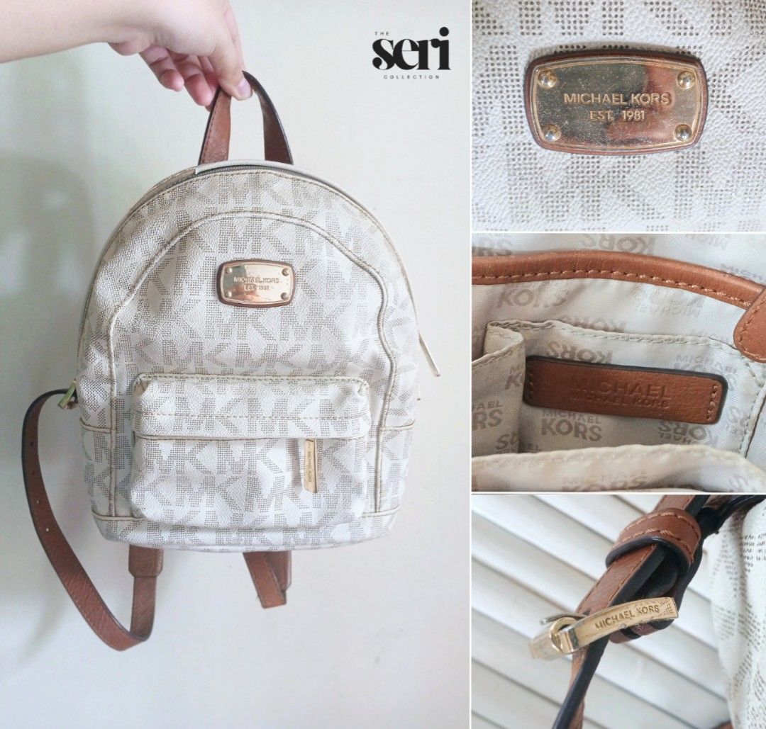 AUTHENTIC Michael Kors Signature Logo Canvas & Leather Mini Backpack (Category: Backpacks) located in Naga. Submitted by thesericollection (Listing ID 1441805108, Image 1). Description: NOTE: Item is available for bargain but please review all photos before purchasing. Product has a minor sign of wear on leather trim and needs cleaning. •Guaranteed Authentic Michael Kors Mini Backpack bought from Japan 🇯🇵 • Exterior Color: White • Gold-tone har