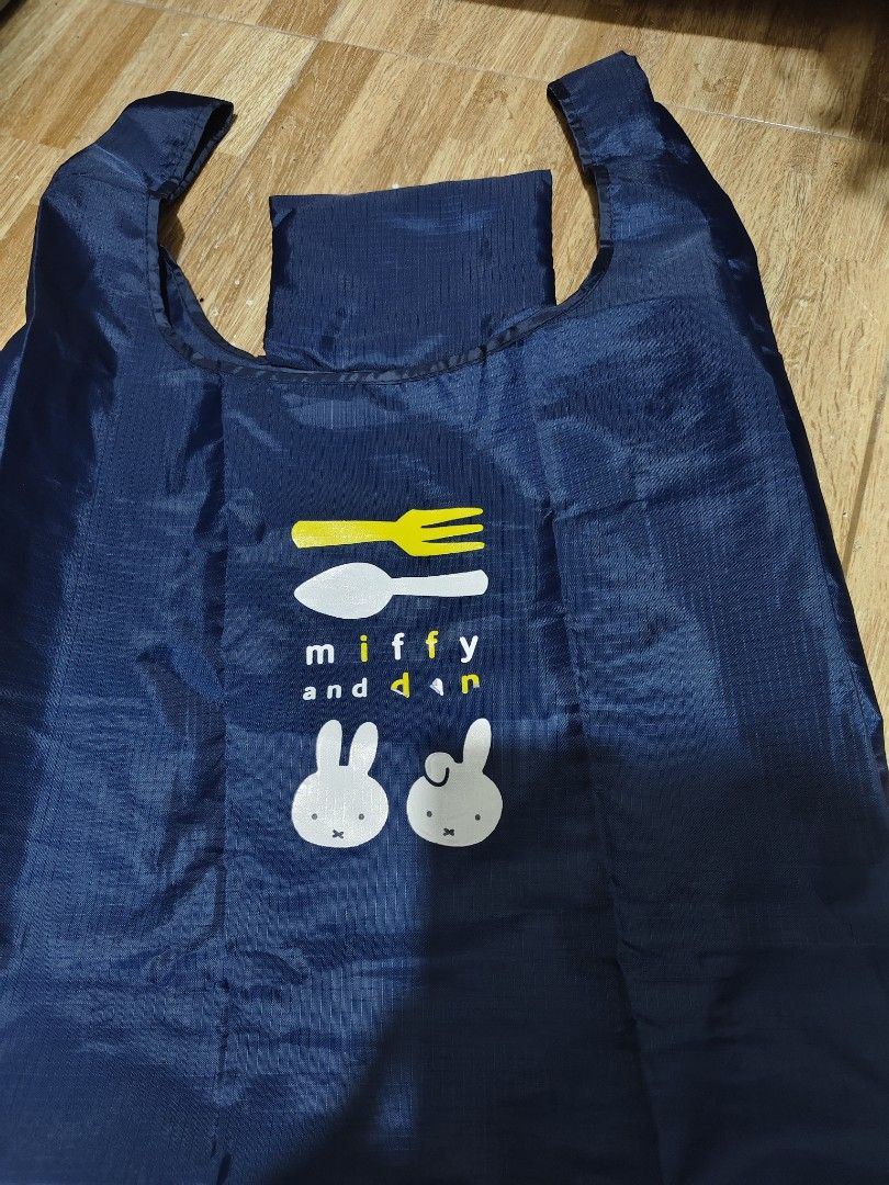 Miffy and dan Navy Blue Foldable Shopping Bag (Category: Tote Bags) located in Makati City. Submitted by abegailbrezuela (Listing ID 1441817481, Image 2). Description: - Cute navy blue reusable shopping bag - Features Miffy and dan characters with cutlery graphic - Folds up small for easy storage - Great for groceries or everyday errands - Lightweight and durable material - Handy to keep in your car or purse.