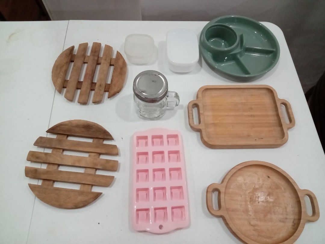 Miscallaneous Kitchen Items - TAKE ALL - Plates, serving dishes, jar, containers, ice mold (Category: Other Kitchenware & Tableware) located in Quezon City. Submitted by cloudcloset.ph (Listing ID 1441812045, Image 1). Description: - Bundle includes: 2 round wooden trivets - Pink silicone ice cube tray with 15 square molds - Small glass mason jar with metal lid and handle - Green divided plate with a central dip bowl - Ideal for serving dishes or