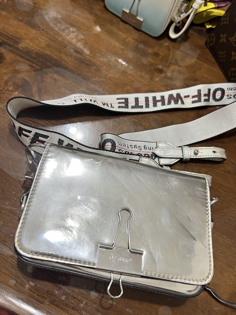 Off-White Silver Binder Clip Crossbody Bag (Category: Luxury Bags & Wallets) located in Pasig City. Submitted by juliadeclutz (Listing ID 1441957156, Image 2). Description: - perfect bag can fit phone, and other usuals - unisex bag with strap - authentic off white, rarely used just stocked rfs: decluttering will buy new ones.