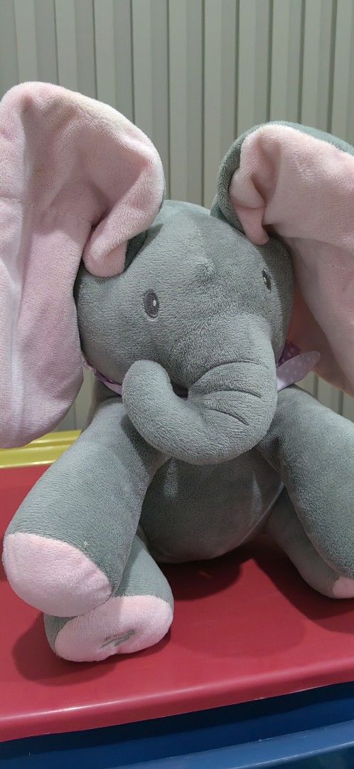 Peek-a-Boo Elephant Plush Toy (Category: Plushies & Soft Toys) located in Tagaytay City. Submitted by mrskai (Listing ID 1441901997, Image 2). Description: - Adorable peek-a-boo elephant plush toy. - Interactive feature: Ears move when foot is pressed. - Soft and cuddly grey elephant with charming pink accents. - Ideal gift for children. - Suitable for both playtime and bedtime. Good Condition. Sounds Working. Just need to replace Battery. Reason