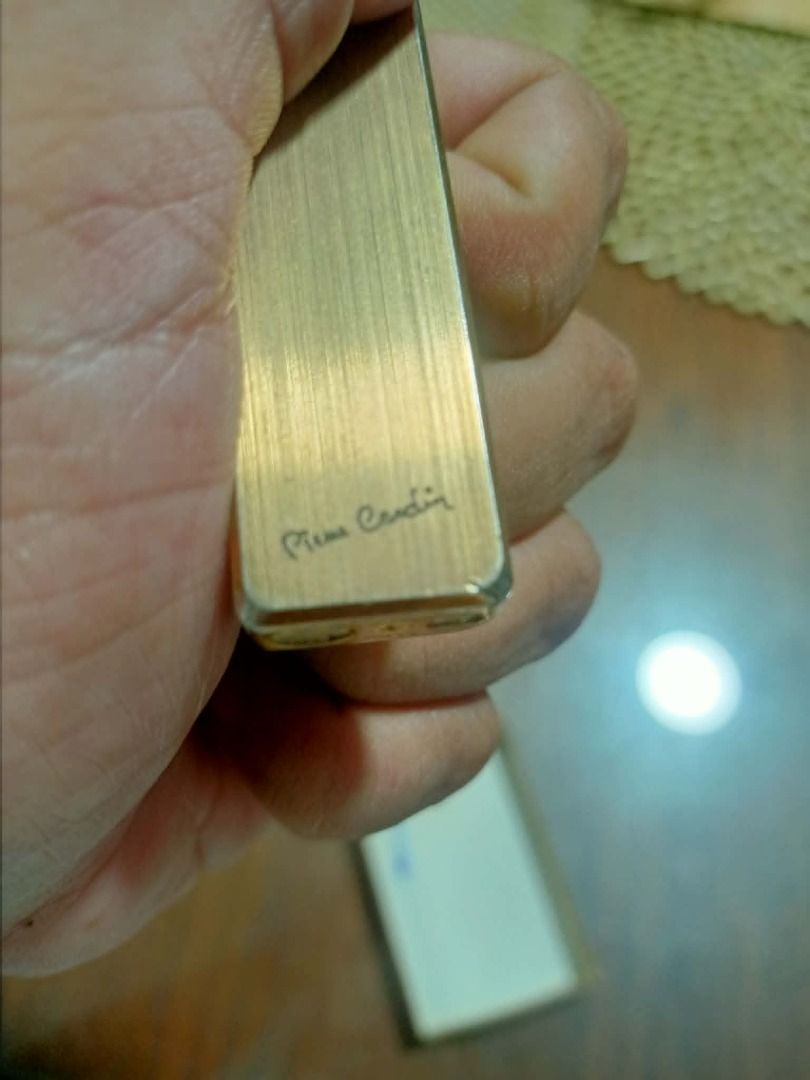 Pierre Cardin Lighter - Vintage Gold (Category: Luxury Accessories) located in Mandaluyong City. Submitted by adriandelacruz3840 (Listing ID 1441829649, Image 1). Description: Vintage Pierre Cardin Slim Gold-Tone Gas Lighter For sale: An authentic, vintage Pierre Cardin pocket gas lighter featuring a sleek, ultra-slim silhouette. It has an elegant brushed gold-tone finish with the classic cursive Pierre Cardin signature beautifully engraved at th