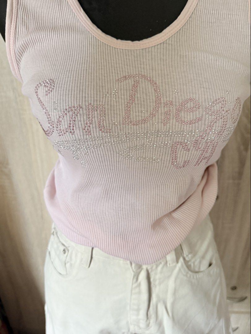 Pink Tank Top (Category: Sleeveless) located in Caloocan City. Submitted by prettyplease000 (Listing ID 1441841097, Image 3). Description: - Cute pink ribbed tank top - "San Diego" text in sparkly rhinestones - Sleeveless design - Scoop neckline - Versatile for casual wear or nights out - Easy to pair with jeans or shorts almost vintage.