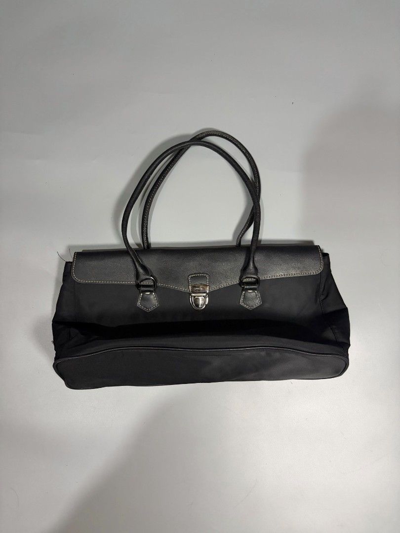 Prada Black Nylon Leather Trim Tote Bag (Category: Luxury Bags & Wallets) located in General Trias. Submitted by happystorm_b8e70b (Listing ID 1441795625, Image 1). Description: - Classic black Prada tote bag - Made in Italy - Mix of durable nylon and premium leather - Secure front clasp closure - Interior zippered pocket - Spacious for essentials - Ideal for daily use or travel.