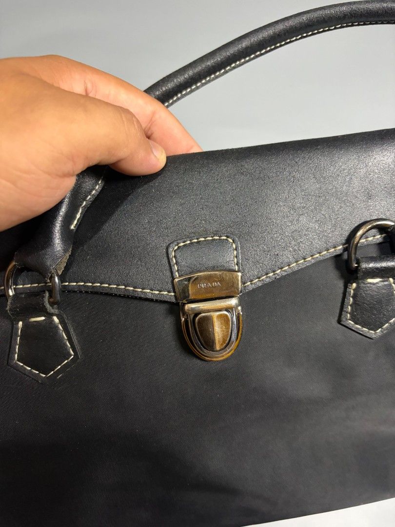 Prada Black Nylon Leather Trim Tote Bag (Category: Luxury Bags & Wallets) located in General Trias. Submitted by happystorm_b8e70b (Listing ID 1441795625, Image 3). Description: - Classic black Prada tote bag - Made in Italy - Mix of durable nylon and premium leather - Secure front clasp closure - Interior zippered pocket - Spacious for essentials - Ideal for daily use or travel.