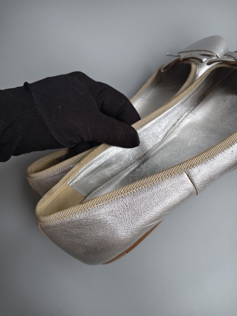 Prada Silver Leather Ballet Flats Bow Detail (Category: Flats & Sandals) located in Binan City. Submitted by eddabrienne (Listing ID 1441855978, Image 3). Description: - Authentic Prada silver leather ballet flats - Size: 35.5 - Features a charming bow detail on the toe - Comfortable slip-on style - Prada logo visible on the insoles - Soles marked with Prada Milano - Made in Italy - Please note: Minor signs of wear on the soles and toe area..
