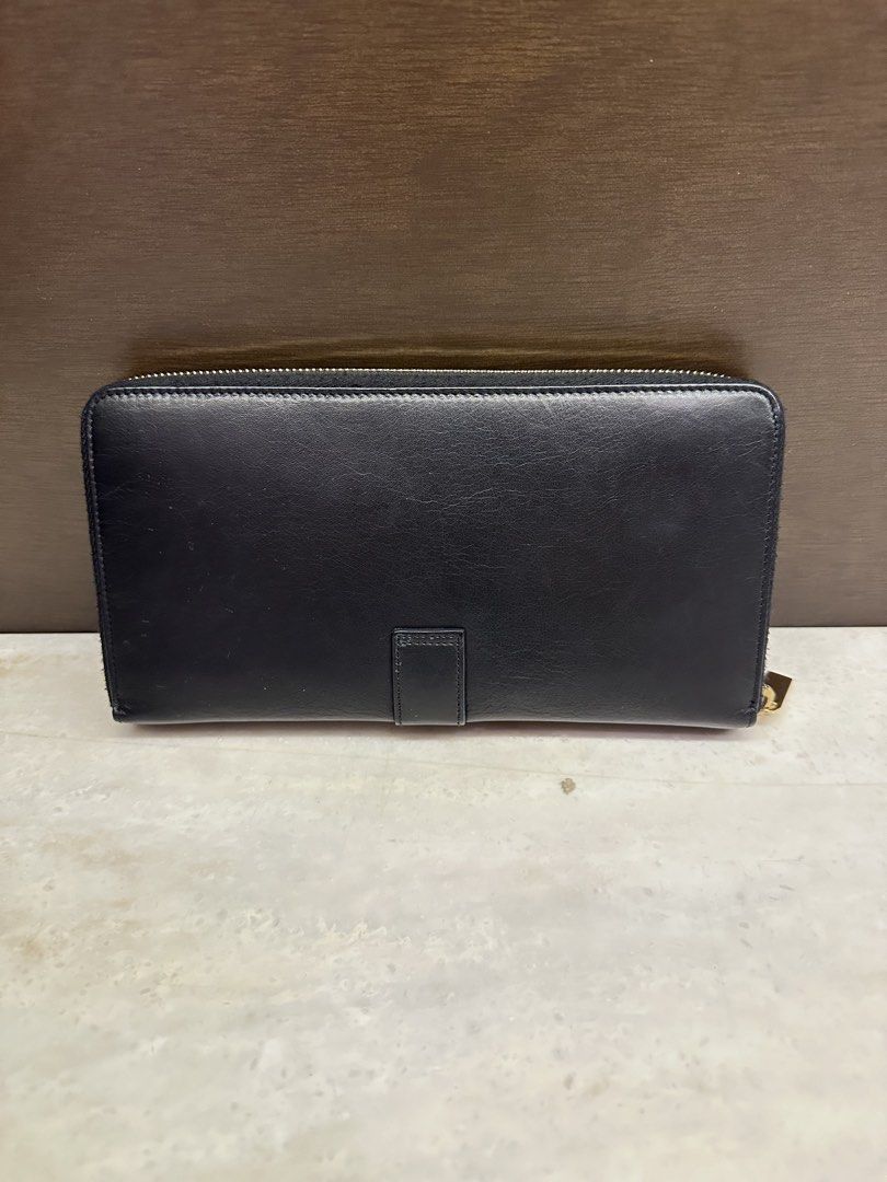 Saint Laurent Black Leather Zip Around Wallet (Category: Luxury Bags & Wallets) located in Quezon City. Submitted by nix888 (Listing ID 1441915393, Image 2). Description: Authentic Saint Laurent black leather zip-around wallet with gold hardware. Features multiple card slots and compartments. Shows minor exterior wear but remains functional and usable. Comes with box and cards. Price is slightly negotiable. .