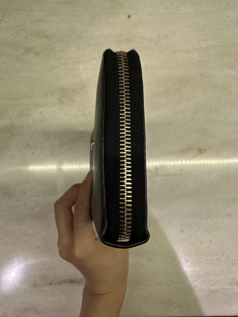 Saint Laurent Black Leather Zip Around Wallet (Category: Luxury Bags & Wallets) located in Quezon City. Submitted by nix888 (Listing ID 1441915393, Image 3). Description: Authentic Saint Laurent black leather zip-around wallet with gold hardware. Features multiple card slots and compartments. Shows minor exterior wear but remains functional and usable. Comes with box and cards. Price is slightly negotiable. .
