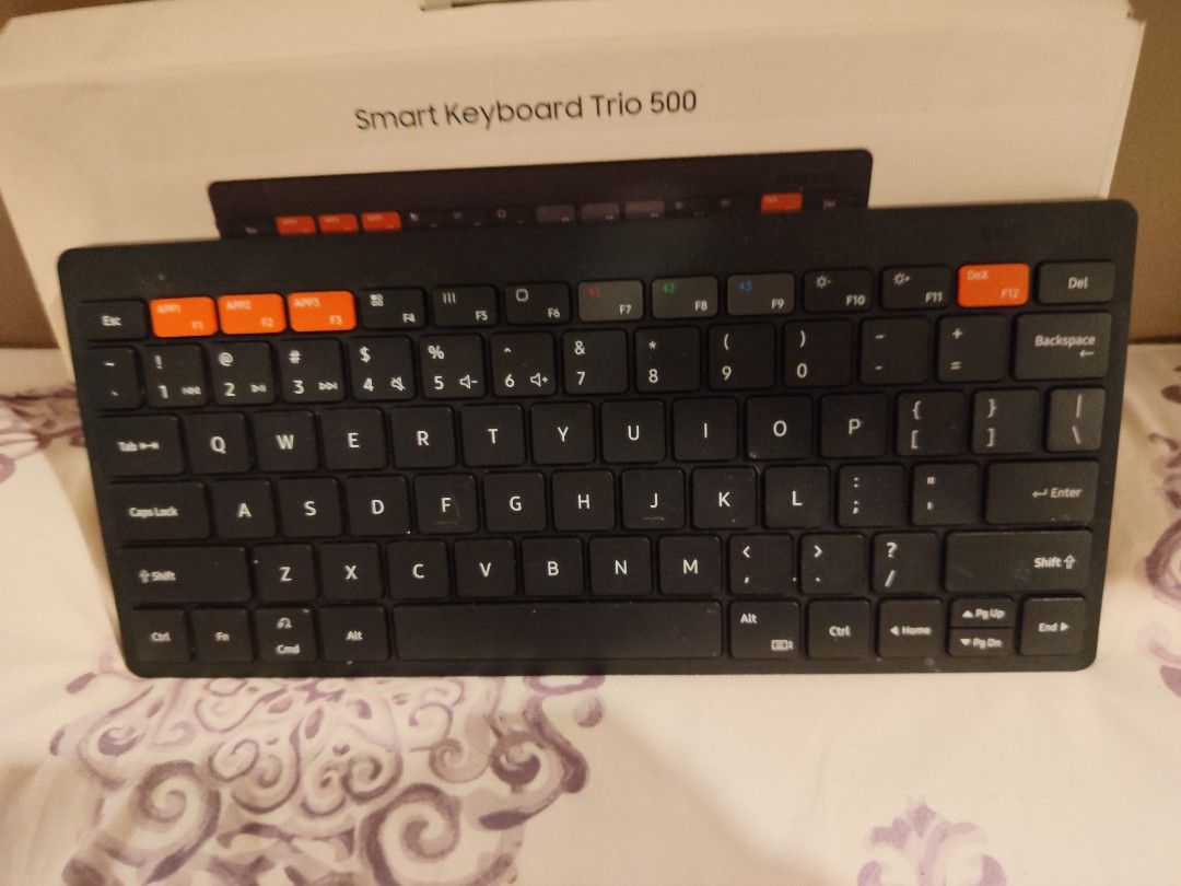 Samsung Smart Keyboard Trio 500 (Category: Computer Keyboard) located in Manila. Submitted by jilliese (Listing ID 1441900857, Image 3). Description: slightly used like new - Samsung Smart Keyboard Trio 500 - Wireless connectivity - Dedicated keys for seamless device switching - Stylish orange accent keys - Compact and portable design - Ideal for multitasking across multiple devices - In excellent working condition.