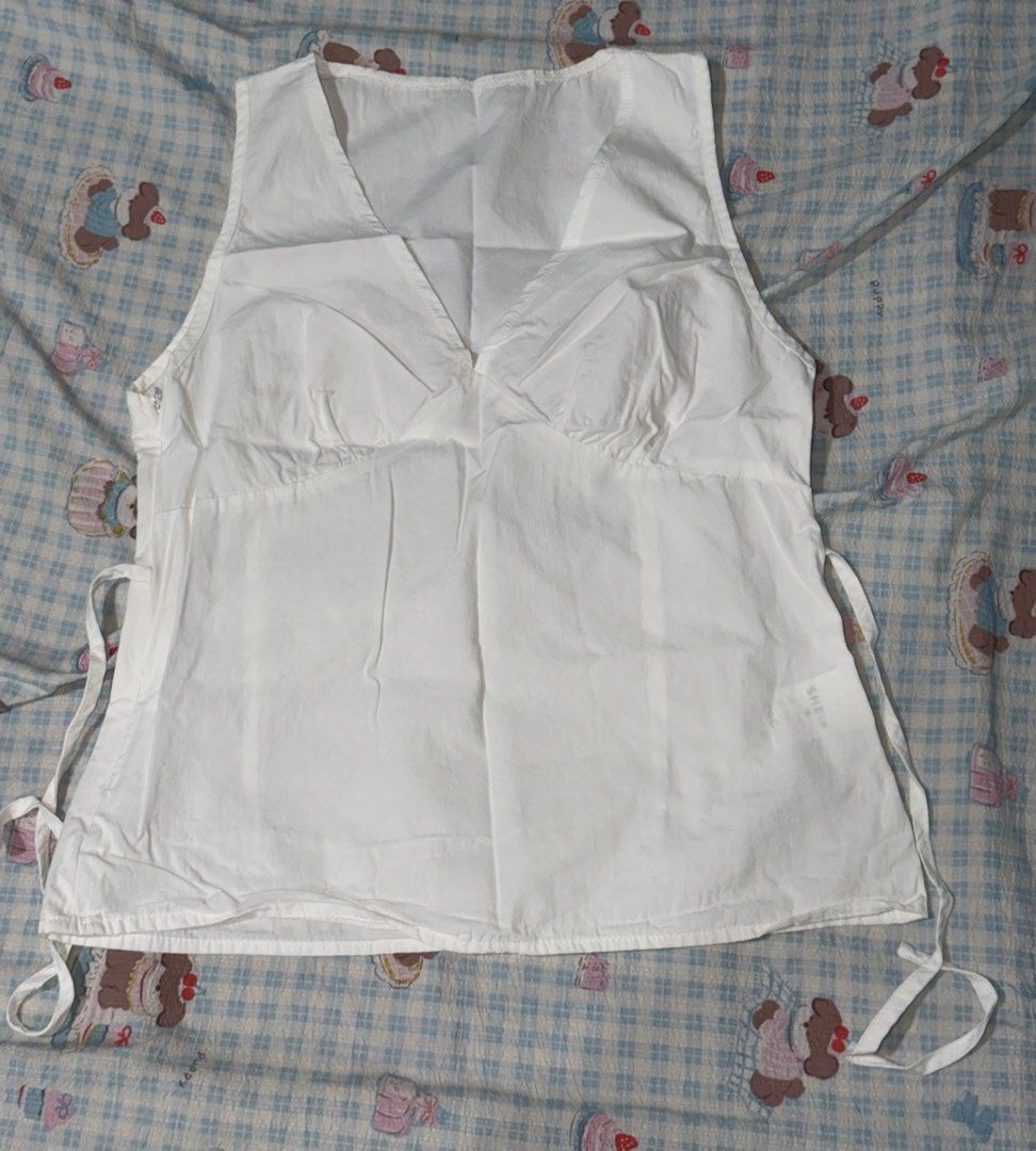 Shein V-Neck White Blouse (Category: Sleeveless) located in Cavite. Submitted by lovedbysham (Listing ID 1441952286, Image 3). Description: - has a small stain on the back - only used once, selling because it does not fit me anymore - perfect for casual wear, picnic date, or summertime .