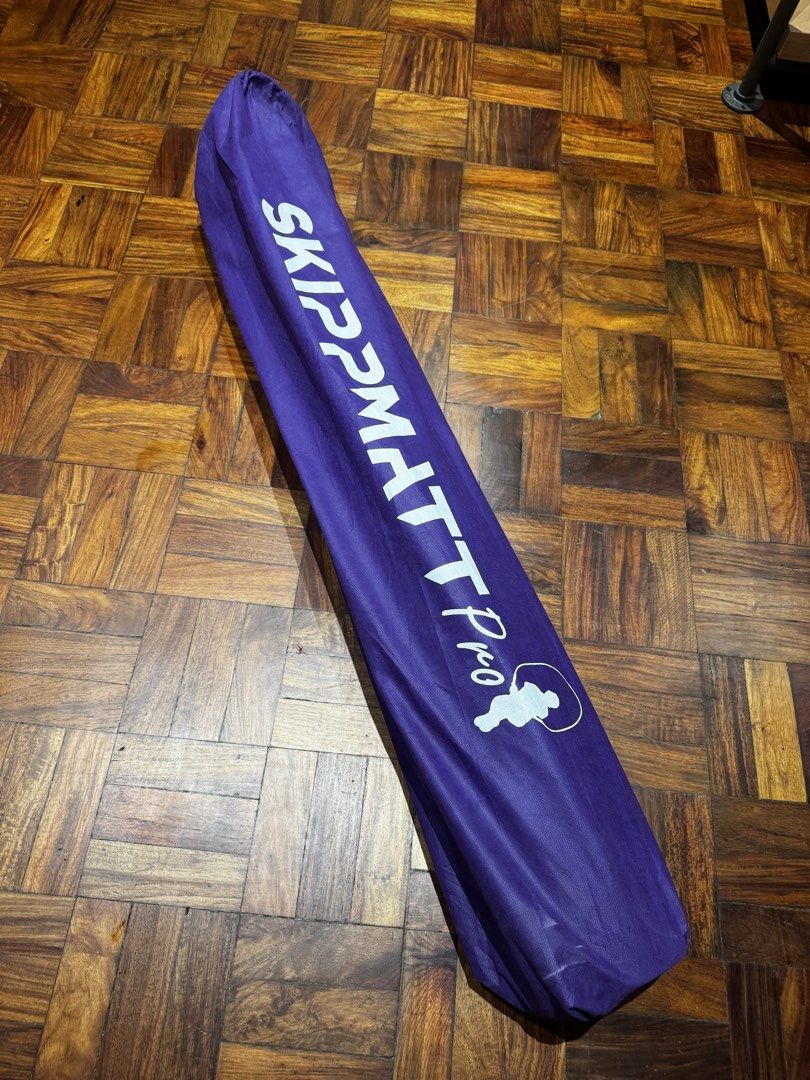 SkippMatt Pro Skipping Rope Mat (Category: Exercise Mats) located in Mandaluyong City. Submitted by j4yw3e (Listing ID 1441903366, Image 3). Description: - Protects your floors from damage and reduce noise while skipping. - Approx. 200cm long and mat is thick and quite heavy. - Suitable for indoor and outdoor use. - Comes with a purple carrying bag and straps. - Visible signs of use such as scuffs from the jump rope. Needs cleaning and conditioni