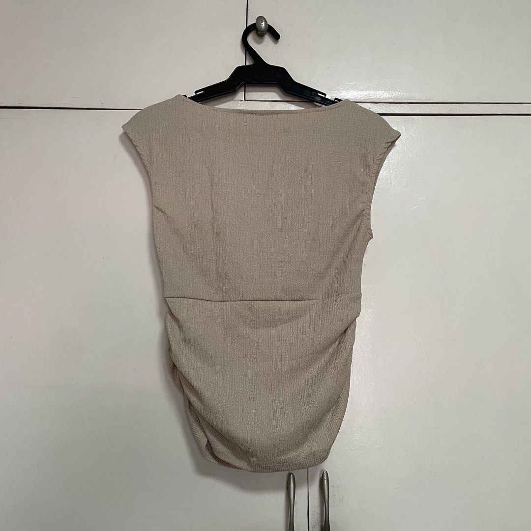 Stradivarius Ruched Cap Sleeve Top Size S (Category: Blouses) located in Manila. Submitted by stuffbyaly (Listing ID 1441906151, Image 2). Description: - Stradivarius Cap Sleeve Top - Color: Beige/Tan - Features: Ruching detail on sides and front - Fabric: Textured appearance - Size: Small Feel free to message if you have any questions or concerns! Please expect replies within 24 hours. Thank you!.