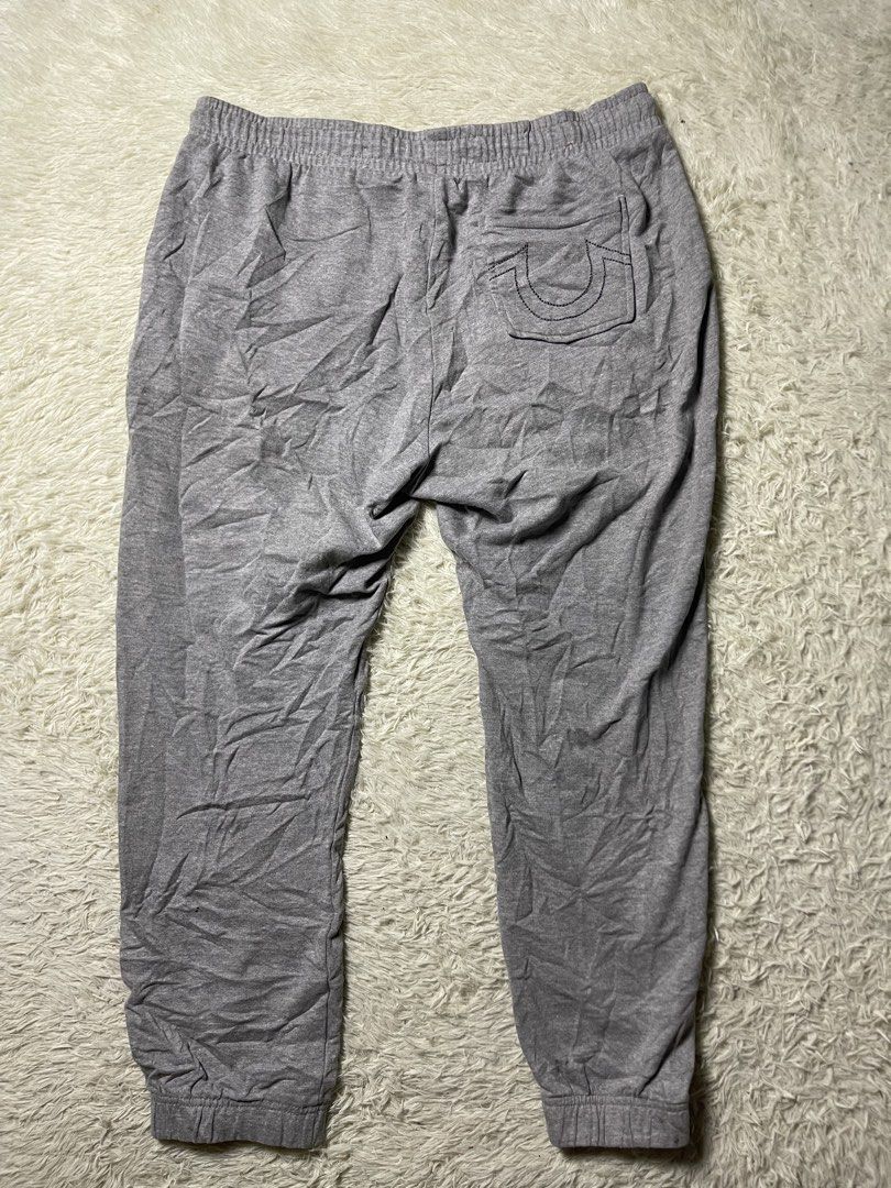 True Religion jogger grey sweatpants (Category: Joggers) located in Matanao. Submitted by jikeserran00389 (Listing ID 1441934421, Image 1). Description: These grey True Religion jogger sweatpants feature the brand’s signature horseshoe logo embroidered on the back pocket. W 32-36 L 35 Excellent Condition .