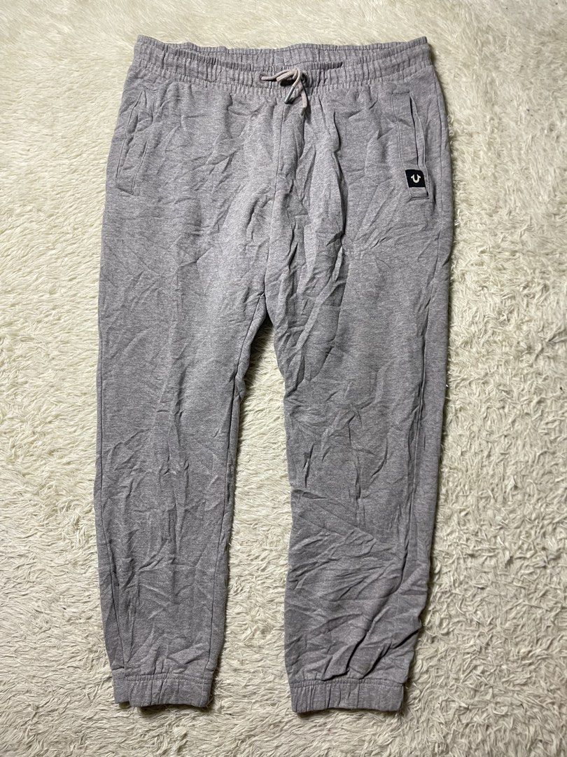 True Religion jogger grey sweatpants (Category: Joggers) located in Matanao. Submitted by jikeserran00389 (Listing ID 1441934421, Image 2). Description: These grey True Religion jogger sweatpants feature the brand’s signature horseshoe logo embroidered on the back pocket. W 32-36 L 35 Excellent Condition .