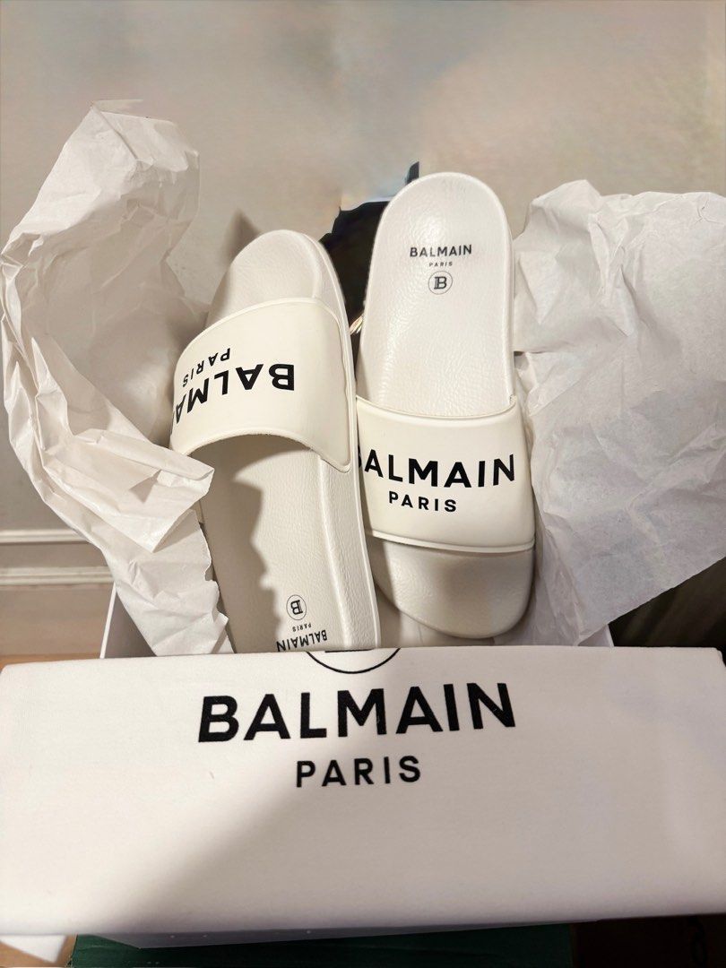 UNUSED Balmain Paris White Slides (Category: Slippers and slides) located in Manila. Submitted by tinseyra (Listing ID 1441871410, Image 1). Description: - Authentic Balmain Paris slides - Color: White - Features Balmain Paris logo across the strap - Includes original box and tissue paper - Ideal for casual wear.