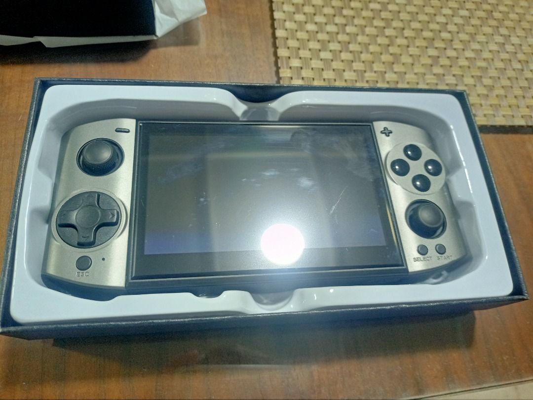 Vädra 09 Ultra Handheld Retro Gaming Console (Category: Others) located in Mandaluyong City. Submitted by adriandelacruz3840 (Listing ID 1441831602, Image 2). Description: Vädra 09 Ultra Handheld Retro Gaming Console For sale: An authentic Vädra 09 Ultra handheld retro gaming console. It features a sleek, ergonomic gunmetal grey body with dual analog sticks, a classic D-pad, four face buttons, and textured side grips for comfortable long gaming s