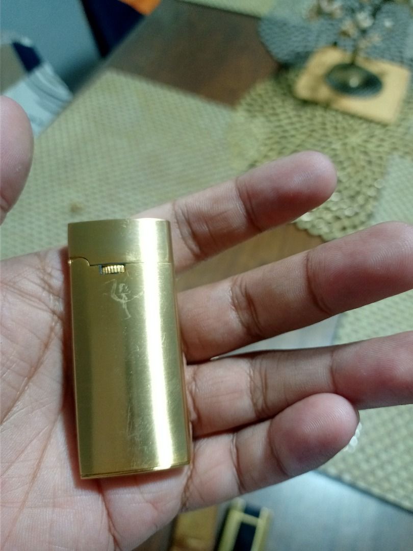 Vintage Windmill Gold-Tone Gas Lighter (Category: Vintage Collectibles) located in Mandaluyong City. Submitted by adriandelacruz3840 (Listing ID 1441830188, Image 1). Description: Vintage Windmill Gold-Tone Gas Lighter For sale: An authentic vintage pocket gas lighter by Windmill. It features a beautifully curved, ergonomic semi-oval shape and a sleek satin/matte gold-tone finish. It has a horizontal roller wheel design beneath the cap flip line 
