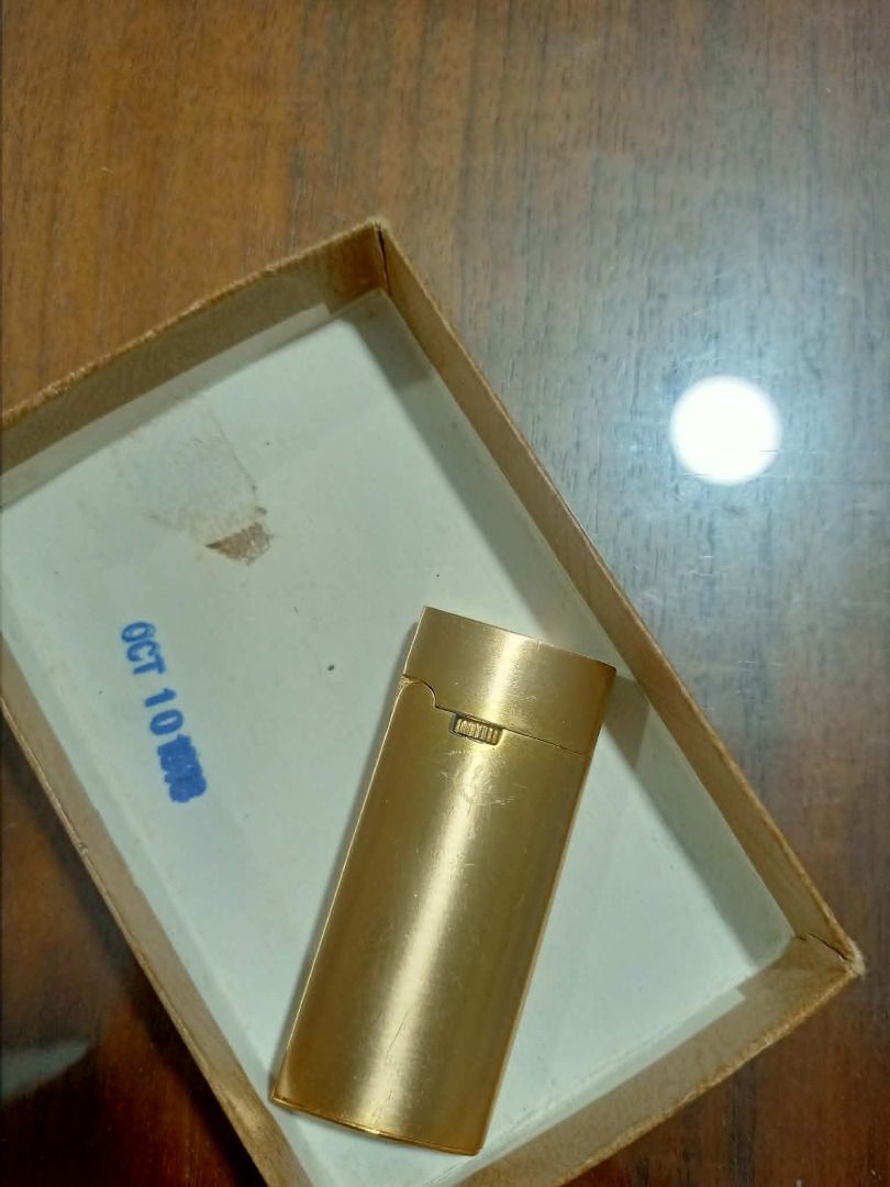 Vintage Windmill Gold-Tone Gas Lighter (Category: Vintage Collectibles) located in Mandaluyong City. Submitted by adriandelacruz3840 (Listing ID 1441830188, Image 2). Description: Vintage Windmill Gold-Tone Gas Lighter For sale: An authentic vintage pocket gas lighter by Windmill. It features a beautifully curved, ergonomic semi-oval shape and a sleek satin/matte gold-tone finish. It has a horizontal roller wheel design beneath the cap flip line 