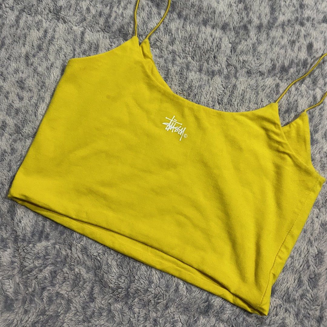 Yellow Stussy Crop Top Spaghetti Strap (Category: Sleeveless) located in Dipolog. Submitted by thriftcher (Listing ID 1441946002, Image 3). Description: - Adorable yellow Stussy crop top - Features delicate spaghetti straps - Prominent Stussy logo print on the front - Subtle Stussy logo detail on the back - Crafted from a soft and stretchy cotton-elastane blend - Ideal for everyday casual outfits see pics for details pm.