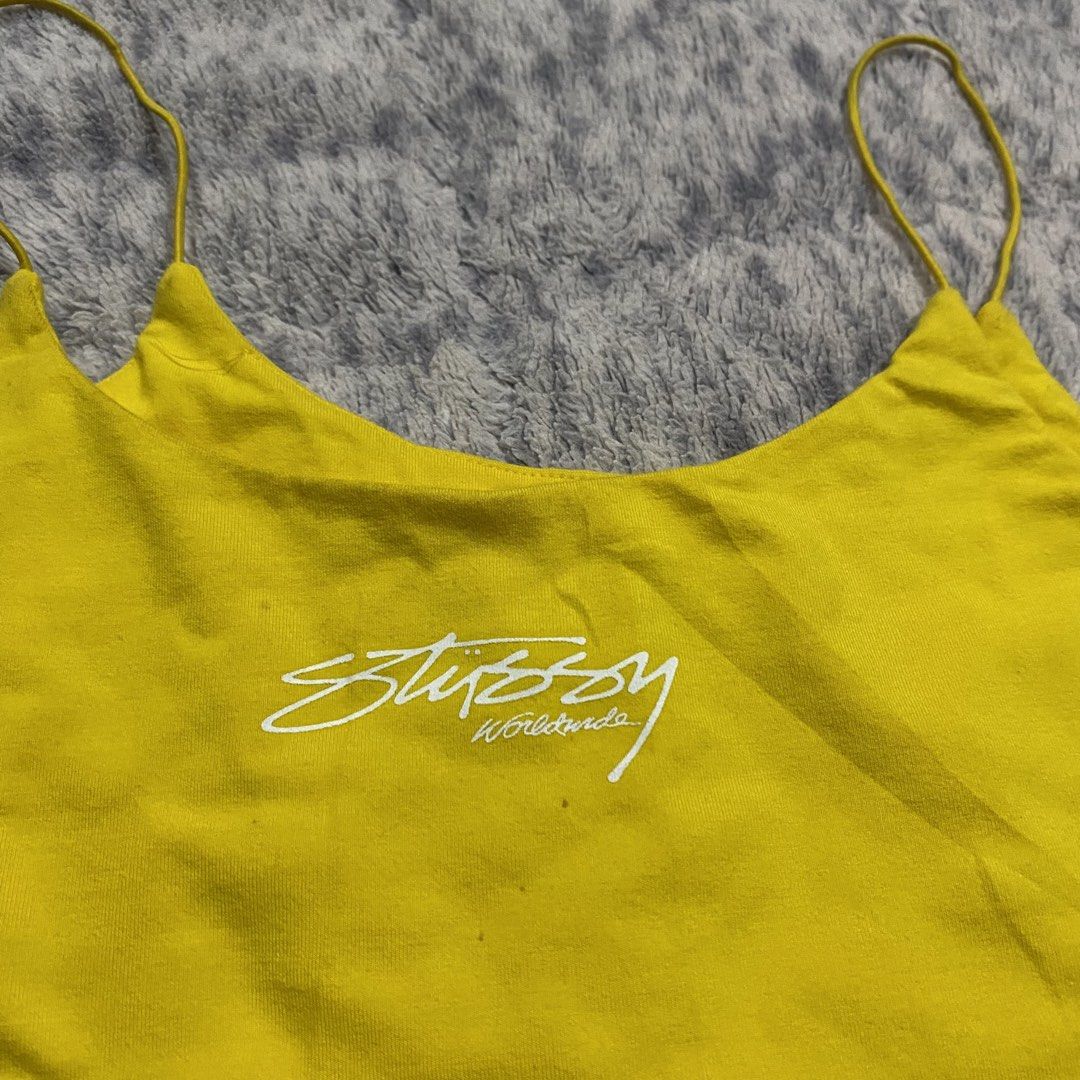 Yellow Stussy Crop Top Spaghetti Strap (Category: Sleeveless) located in Dipolog. Submitted by thriftcher (Listing ID 1441946002, Image 2). Description: - Adorable yellow Stussy crop top - Features delicate spaghetti straps - Prominent Stussy logo print on the front - Subtle Stussy logo detail on the back - Crafted from a soft and stretchy cotton-elastane blend - Ideal for everyday casual outfits see pics for details pm.