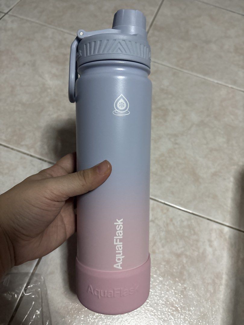 AquaFlask 22oz Marshmallow Water Bottle (Category: Water Bottles & Tumblers) located in Malabon City. Submitted by jinisells (Listing ID 1439204593, Image 2). Description: - AquaFlask 22oz water bottle - Color: Marshmallow (gradient blue and pink) - Features: - Protective silicone base - Flip-top lid - Comes with original packaging.