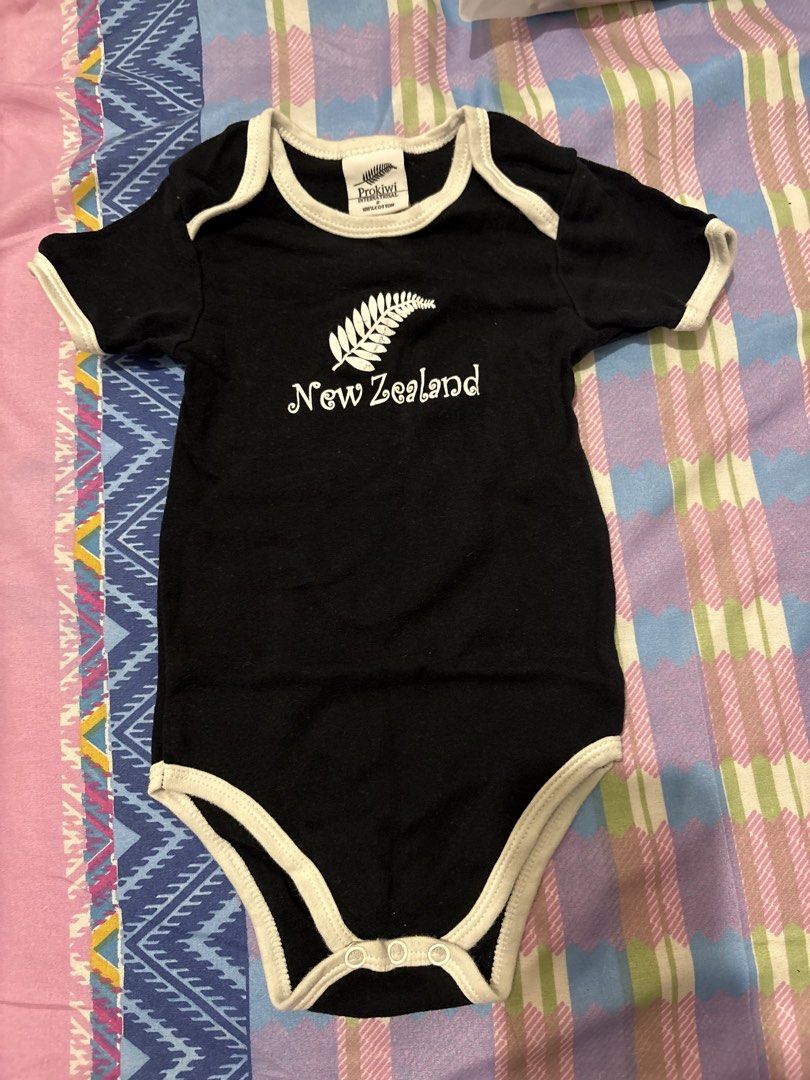 Baby Onesies and Pants Set (Category: Babies & Kids Fashion) located in Pasig City. Submitted by dianexing (Listing ID 1442141715, Image 2). Description: - Bundle of 3 baby clothes - Includes: grey short-sleeve onesie, black 'New Zealand' onesie (fern print), white pants ('Little Dino' print) - Ideal for everyday wear - All items are clean and ready for a new home.