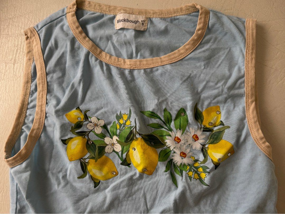 Blackbough Baby Tee Lemon Print Blue Size S (Category: Shirts) located in Las Pinas. Submitted by materialgowrl (Listing ID 1442067791, Image 1). Description: - Brand: Blackbough - Style: Baby Tee - Color: Light Blue - Print: Lemon and Floral - Trim: Tan neckline and sleeves - Size: S - Perfect for summer vibes.