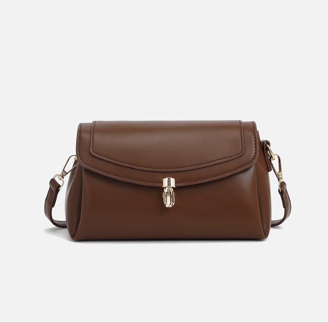 Brown Leather Shoulder Bag with Gold Clasp (Category: Shoulder Bags) located in Manila. Submitted by pinga_crystal (Listing ID 1442135151, Image 1). Description: - Cute brown shoulder bag - Made of faux leather - Features a gold clasp closure - Adjustable strap for comfort - Compact size, fits a smartphone - Ideal for everyday wear or evening events.