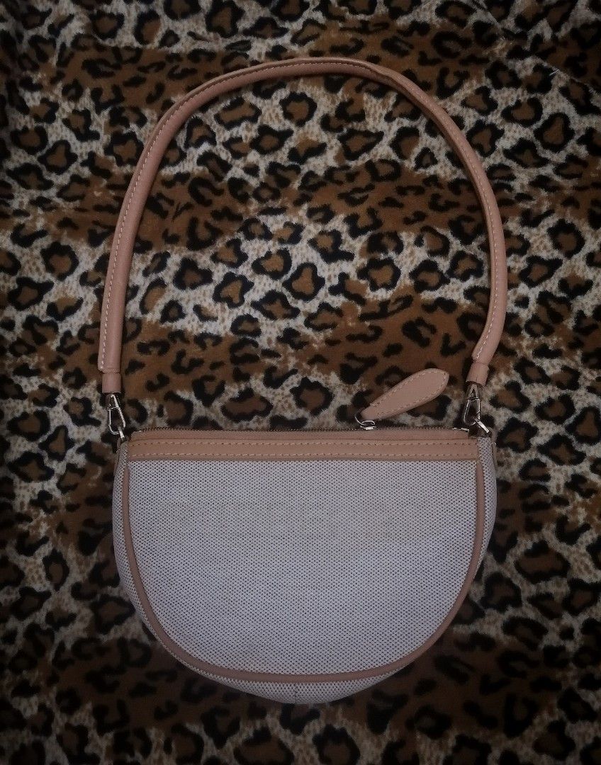Burberry Canvas and Leather Half Moon Shoulder Bag (Category: Luxury Bags & Wallets) located in Cebu City. Submitted by roadthrift (Listing ID 1442009846, Image 1). Description: - Authentic Burberry shoulder bag - Color: Beige canvas with tan leather trim and strap - Closure: Zipper - Interior: Features card slots - Origin: Made in Italy - Condition: Zipper not working, Clean inside and out, excellent for everyday use.