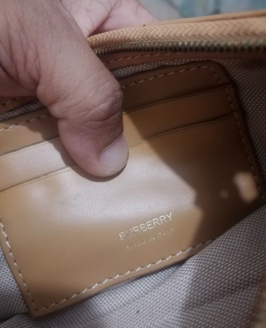 Burberry Canvas and Leather Half Moon Shoulder Bag (Category: Luxury Bags & Wallets) located in Cebu City. Submitted by roadthrift (Listing ID 1442009846, Image 3). Description: - Authentic Burberry shoulder bag - Color: Beige canvas with tan leather trim and strap - Closure: Zipper - Interior: Features card slots - Origin: Made in Italy - Condition: Zipper not working, Clean inside and out, excellent for everyday use.