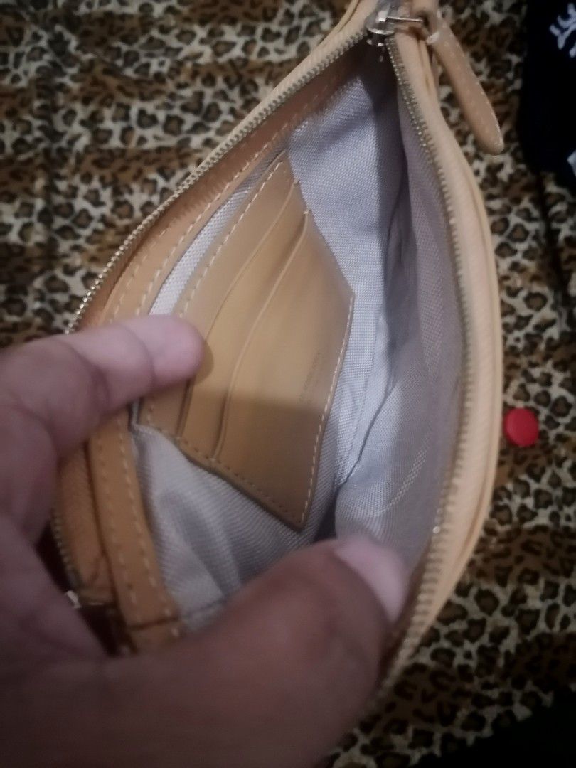 Burberry Canvas and Leather Half Moon Shoulder Bag (Category: Luxury Bags & Wallets) located in Cebu City. Submitted by roadthrift (Listing ID 1442009846, Image 2). Description: - Authentic Burberry shoulder bag - Color: Beige canvas with tan leather trim and strap - Closure: Zipper - Interior: Features card slots - Origin: Made in Italy - Condition: Zipper not working, Clean inside and out, excellent for everyday use.